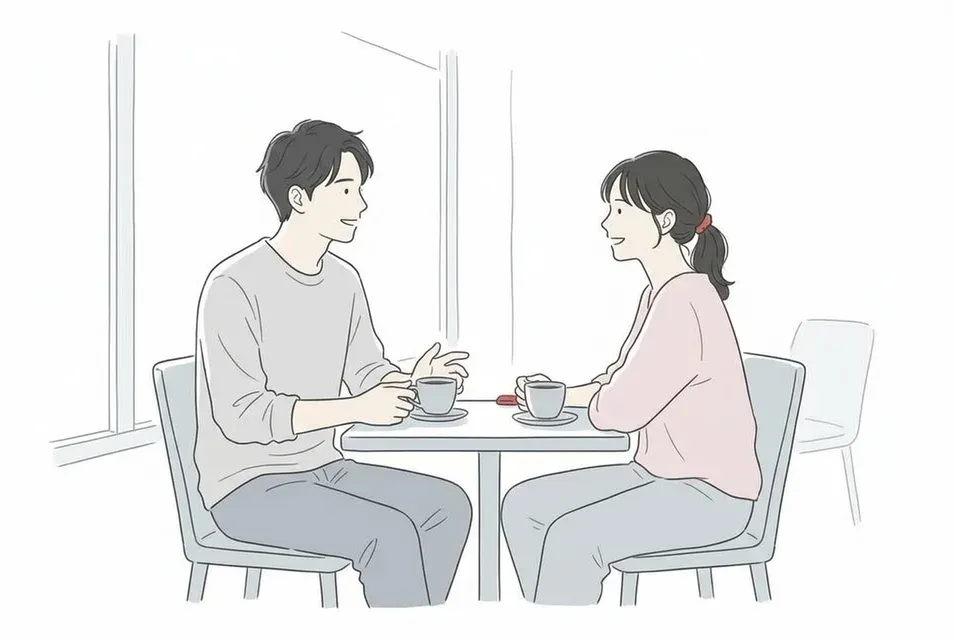 朝日が差し込むカフェの窓際で穏やかに会話を楽しむ男女