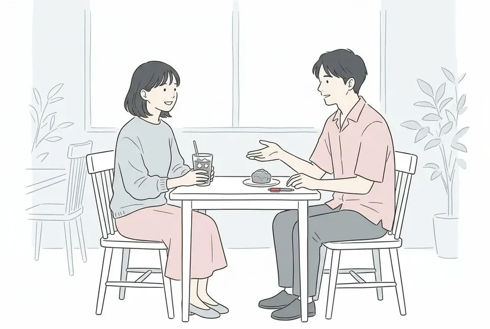 明るいカフェでテーブル越しに穏やかに会話を楽しむ男女
